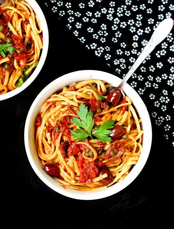 Pasta alla puttanesca with canned tomatoes, garlic, red pepper flakes, olives and anchovies.