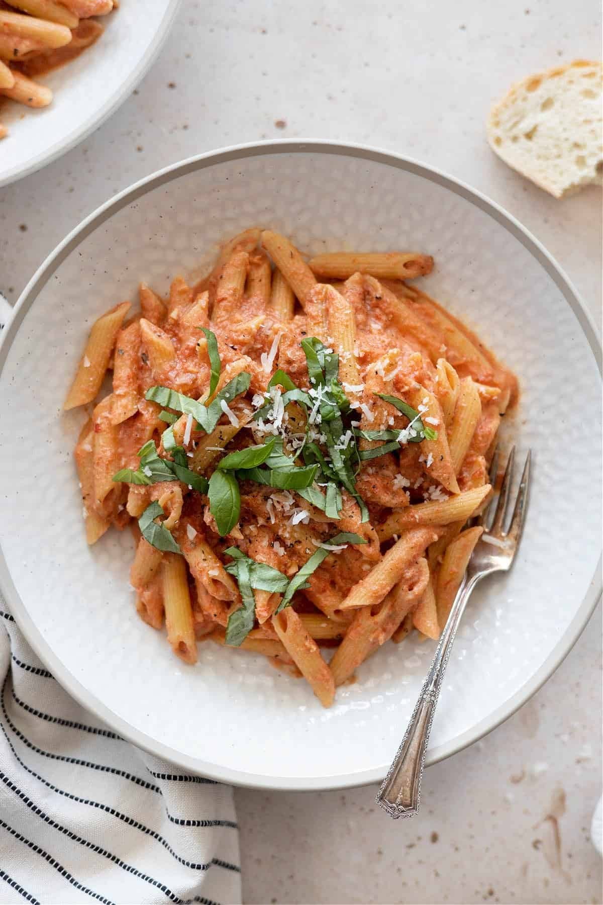 Penne pasta with creamy tomato sauce, parmesan cheese and chopped parsley leaves. 