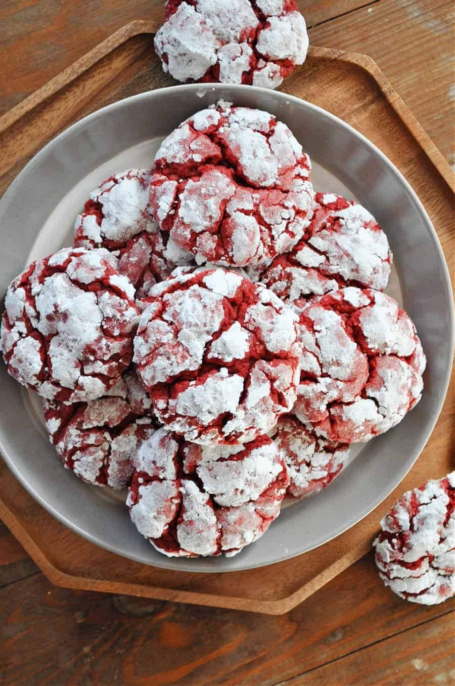 Bunch of red velvet crinkle cookies on plate. 