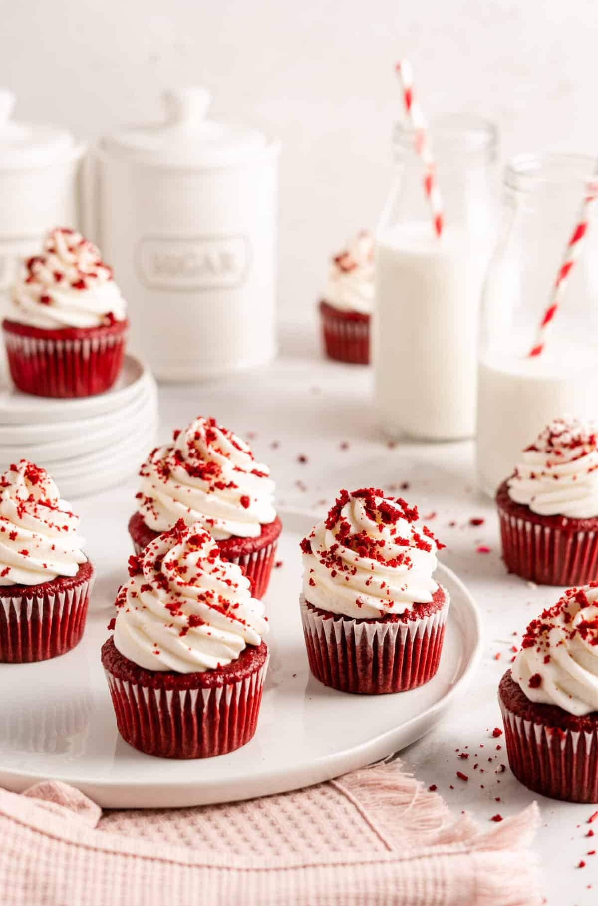 Red velvet cupcakes topped with cream frosting.