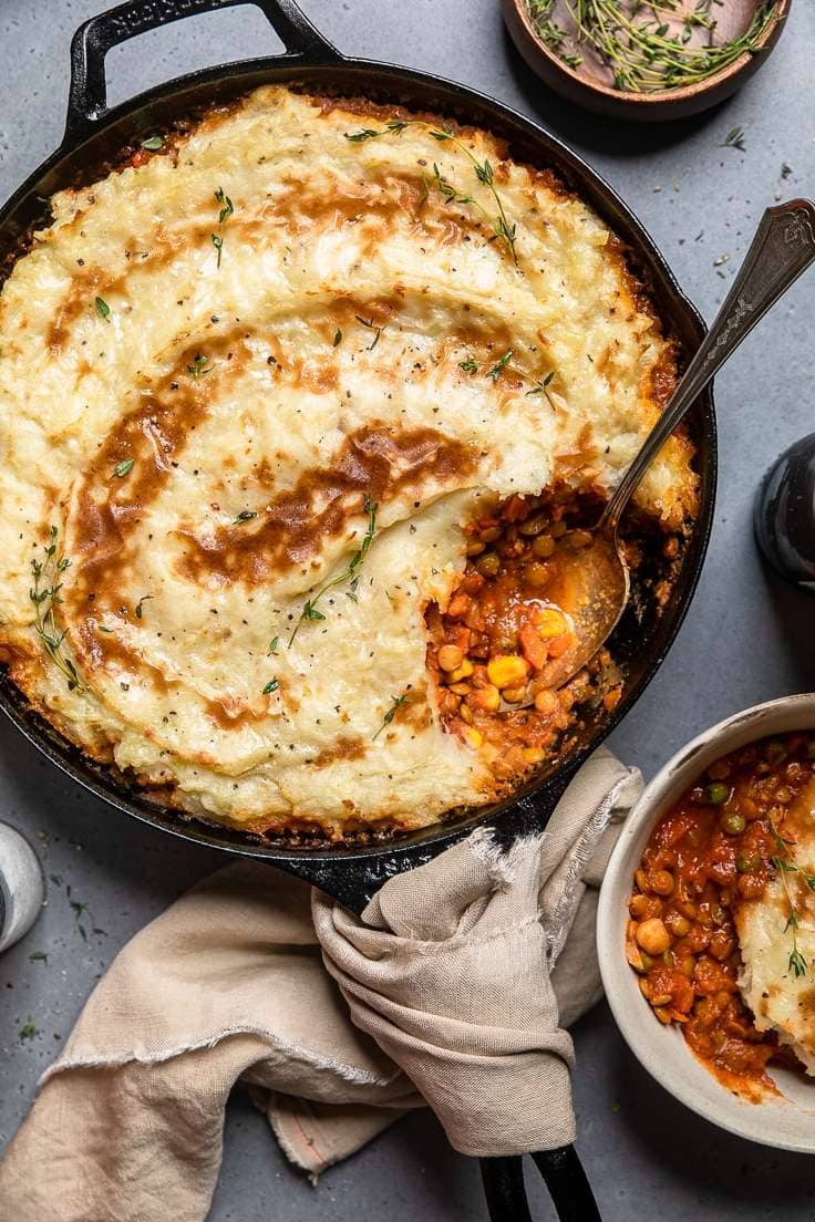 Shepherd's pie with creamy potato toppings filled with veggies and sauce cooked on a skillet.