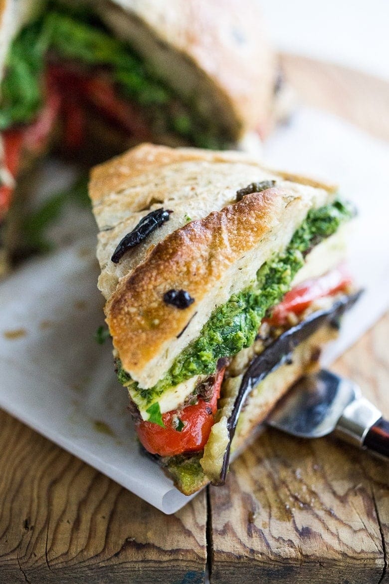 Sandwich with grilled eggplant, roasted peppers, and basil pesto filling. 