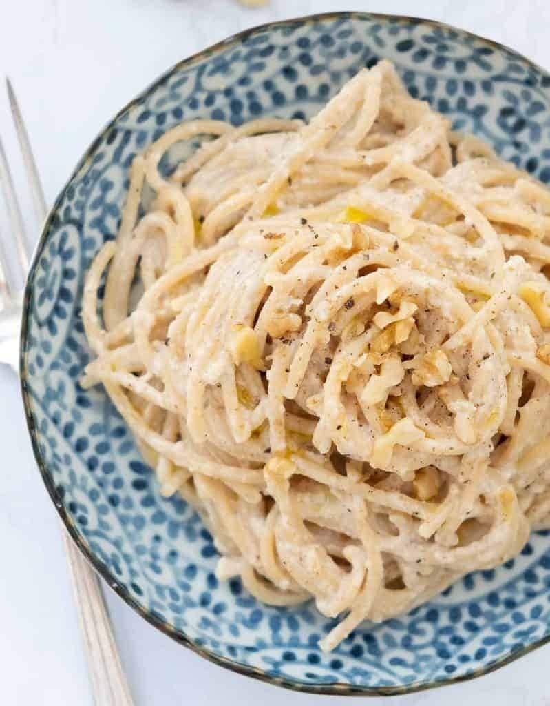 pasta with creamy walnut sauce served on a plate.