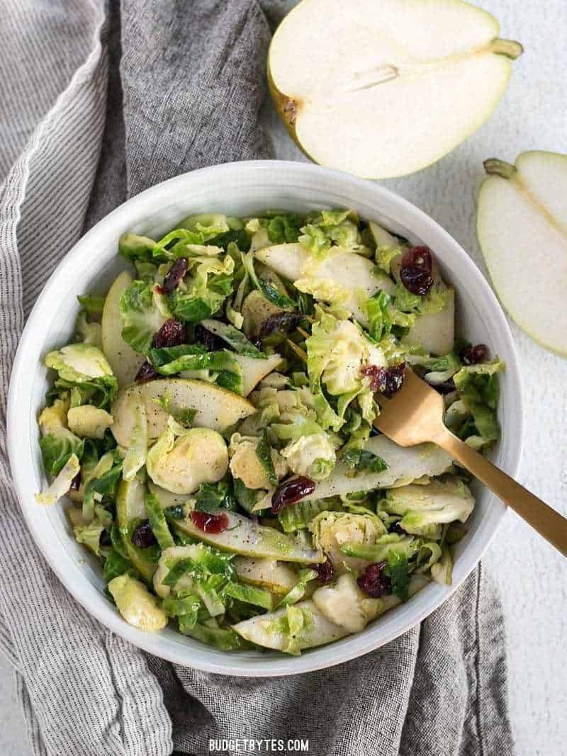 Salad made with shredded brussels, pears and cranberries.