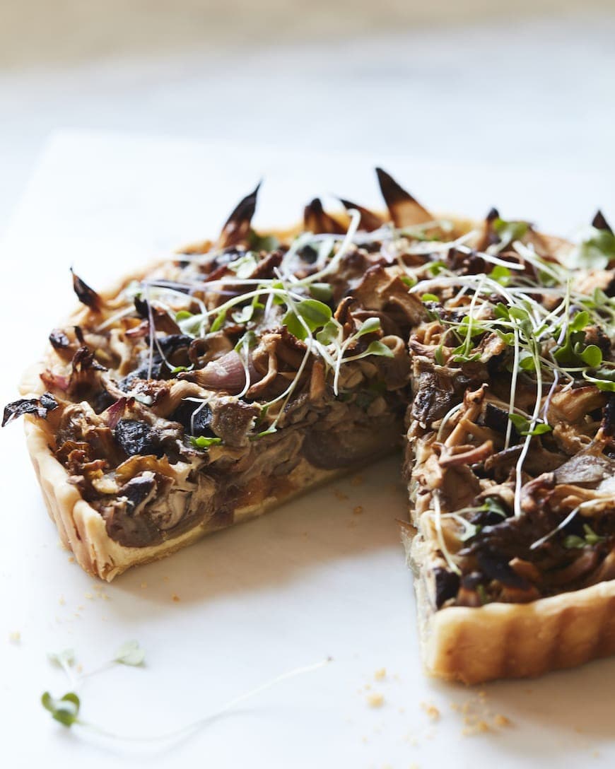 Tart topped with mushroom and ricotta cheese. 