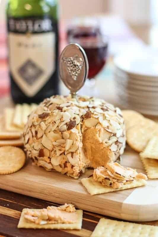 Cheeseball covered with toasted almond served with crackers. 