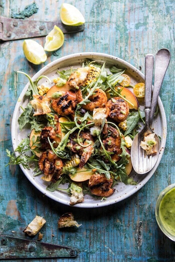 Grilled shrimp salad with peaches, tomatoes and avocado vinaigrette. 