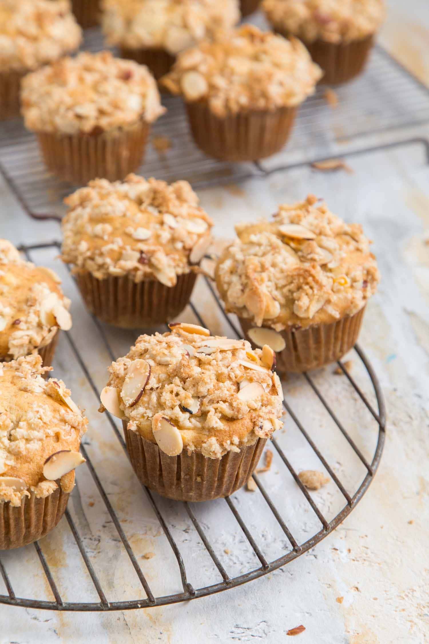 Banana jackfruit muffins with almond coconut crumble on a cooling rack.