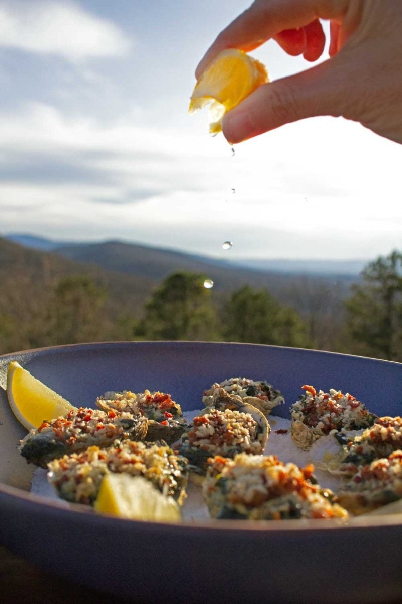 Oysters topped with spinach, Parmesan, bacon, and panko breadcrumbs, spritzed with lemon. 