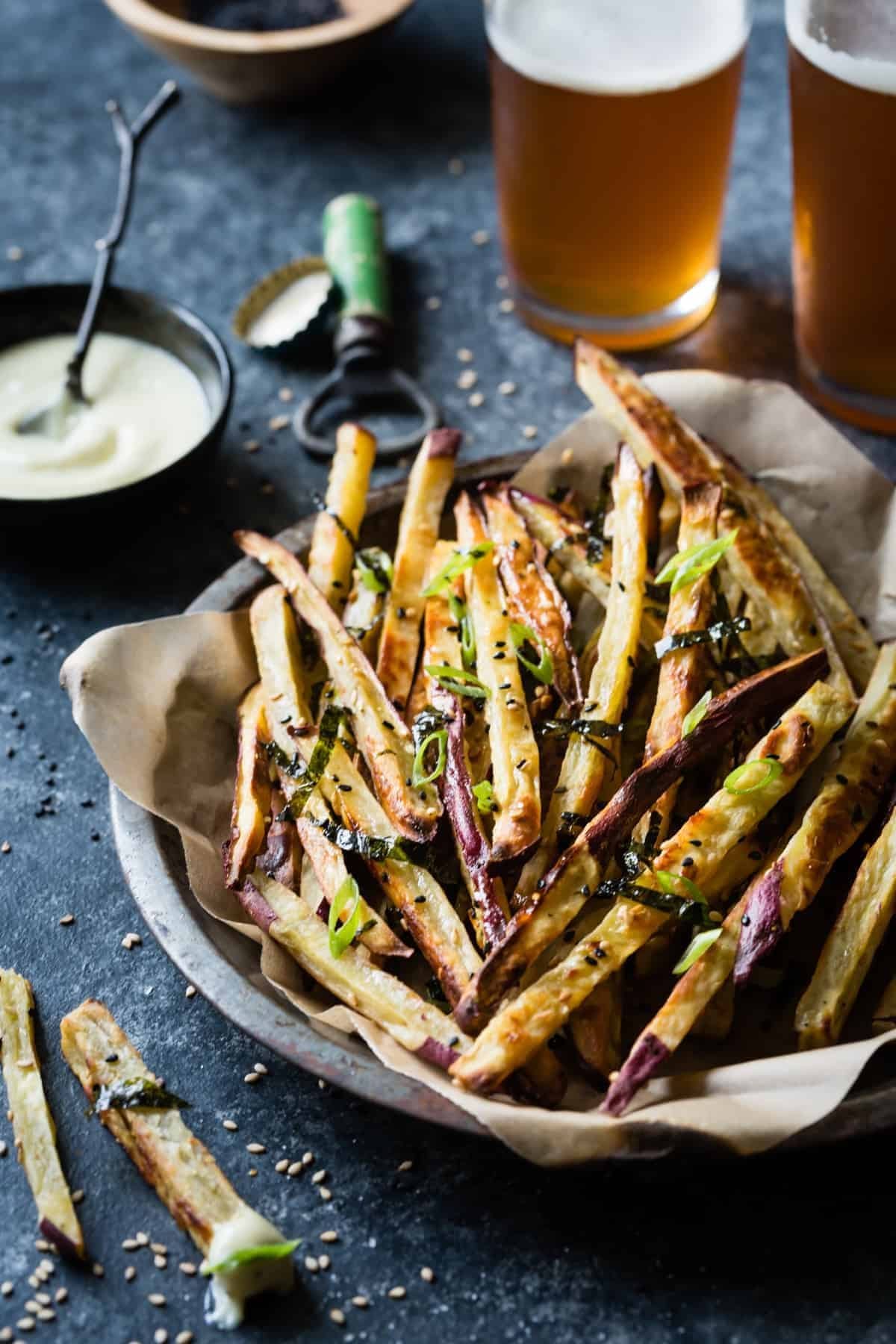Crispy homemade sweet potato with sesame seeds and scallions in a dish