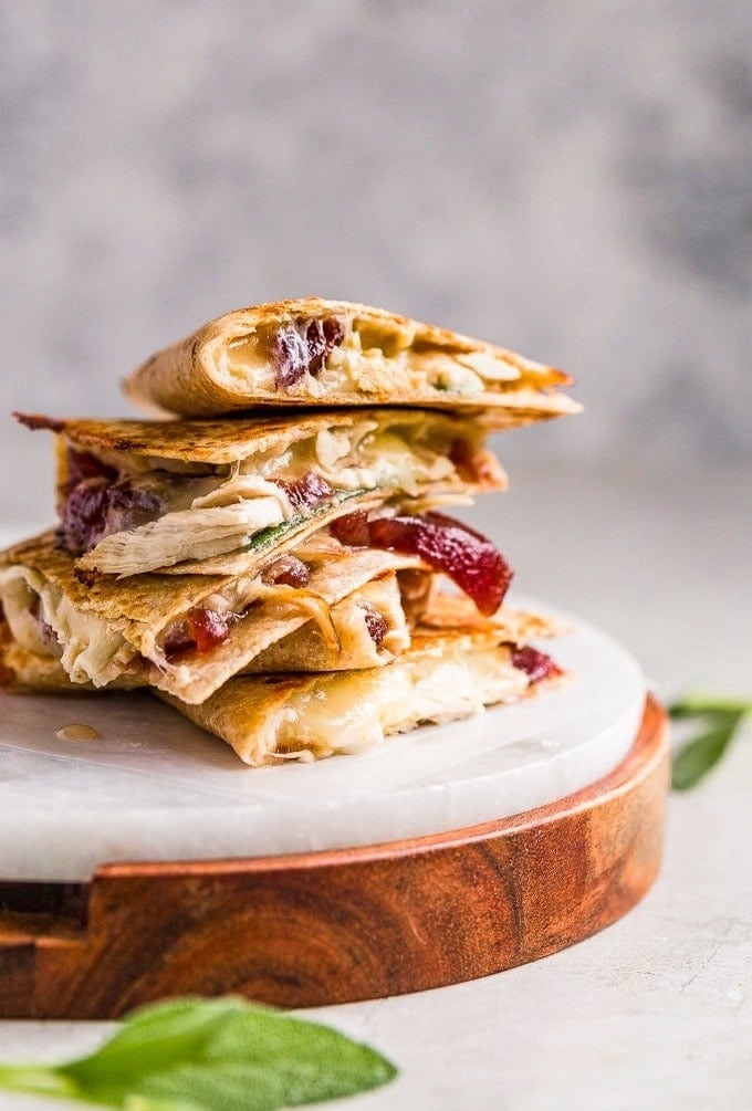 A stack of quesadilla with turkey, cheese and cranberry filling. 
