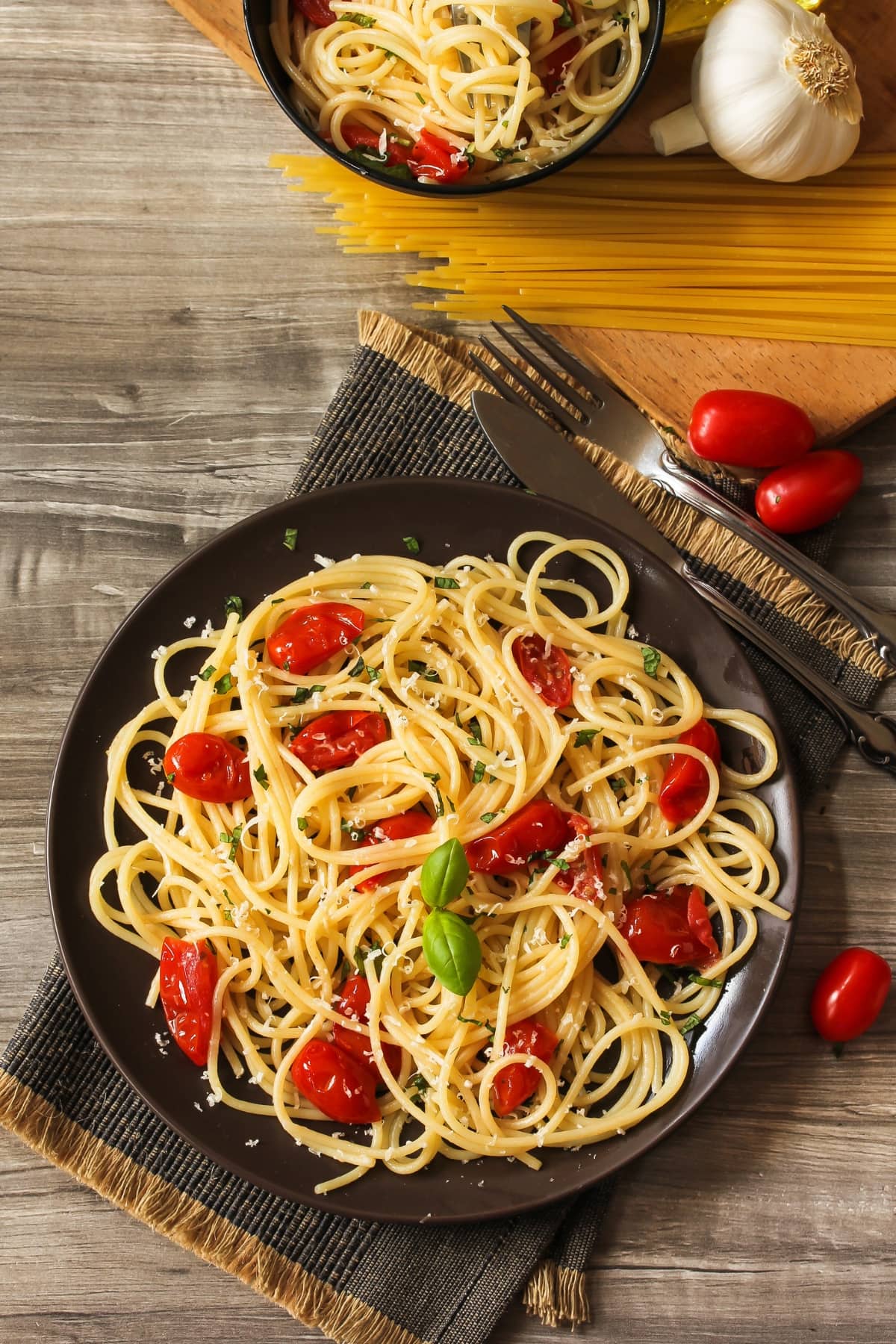 Low Calorie Pasta Recipes featuring angel hair pasta with red tomatoes and basil (top view)