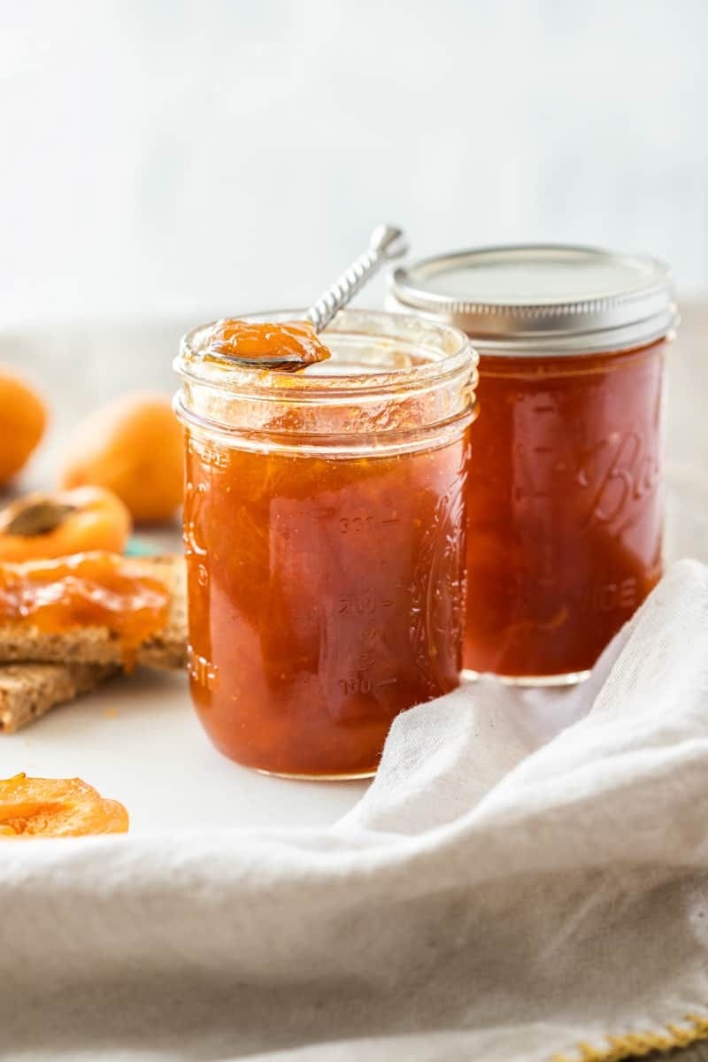 Two mason jars with apricot jam. 