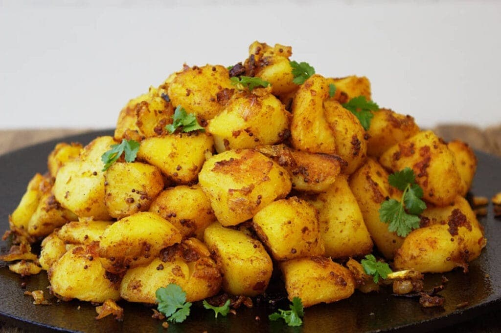 Bunch of Bombay potatoes on a plate. 