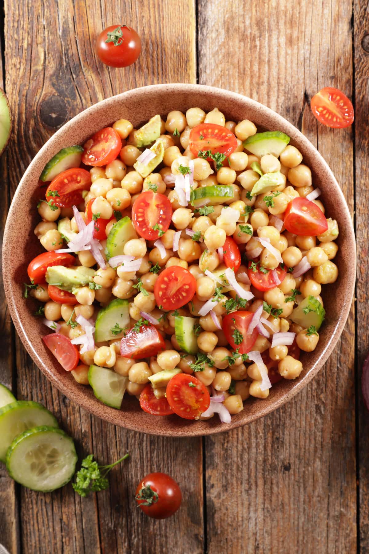 Easy Chickpea Salad Recipe: Chickpea salad in a wooden bowl with  chickpeas, juicy tomatoes, crunchy cucumbers, creamy avocado.