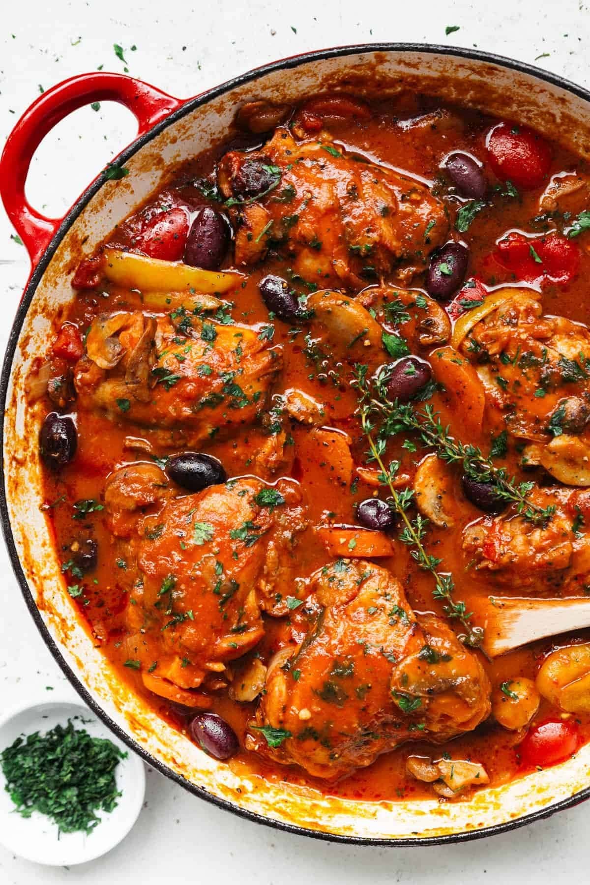 A pot of chicken cacciatore with rich, herby tomato sauce. 