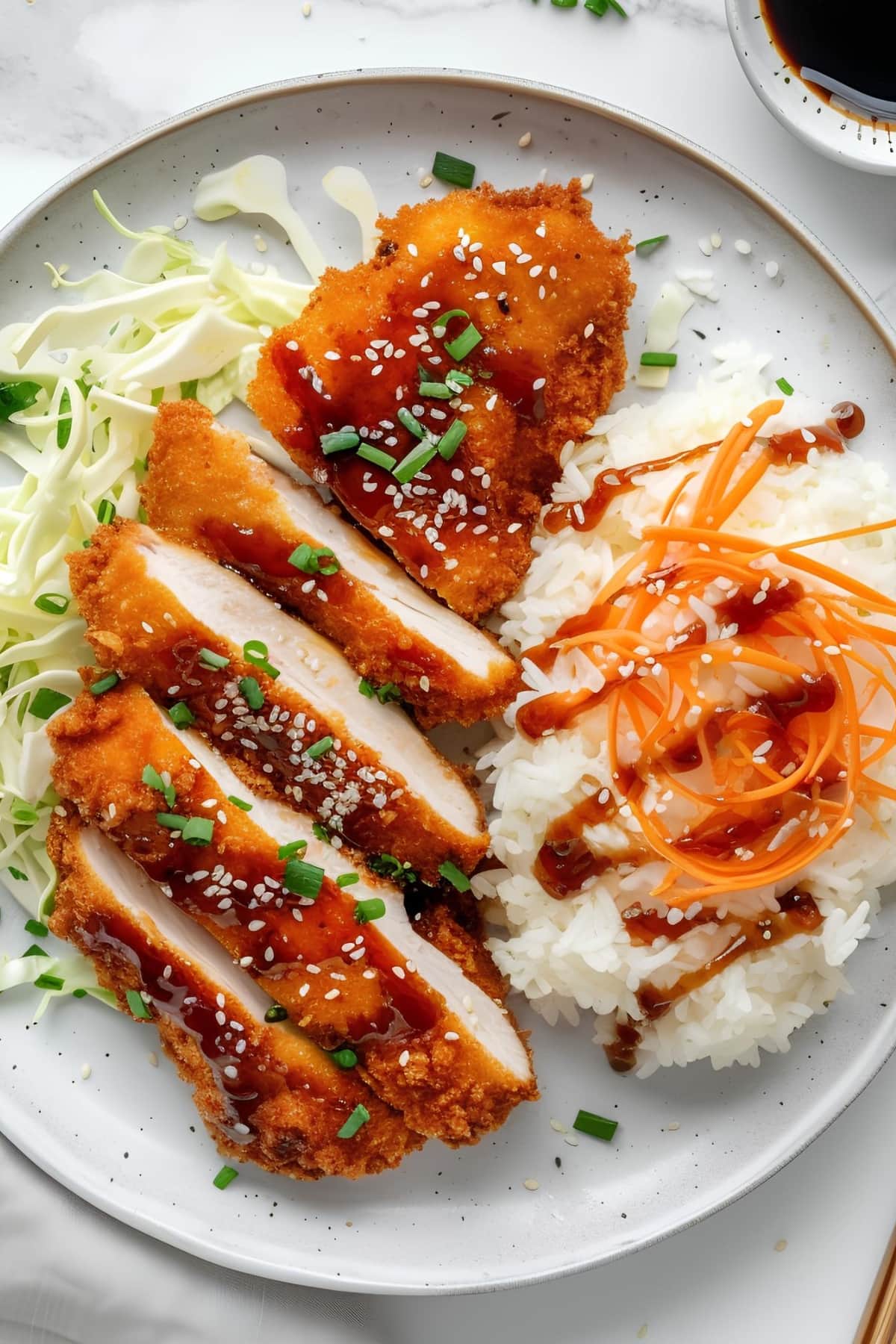 Chicken katsu served with rice and cabbage salad