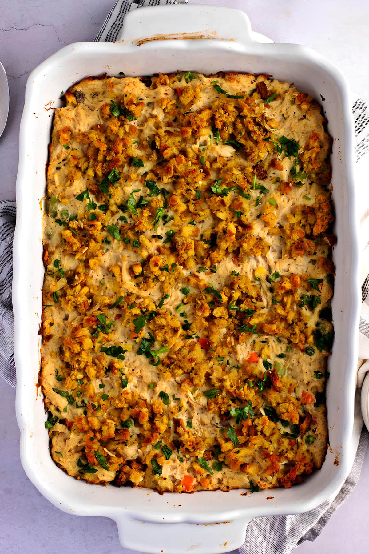 Chicken stuffing casseroled baked on a rectangular white dish. 
