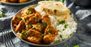 Tikka Masala in a Plate Served with Rice and Naan Bread