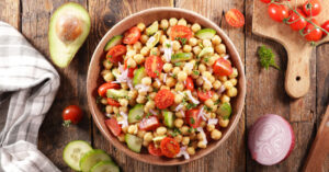 Chickpea salad on wooden bowl.