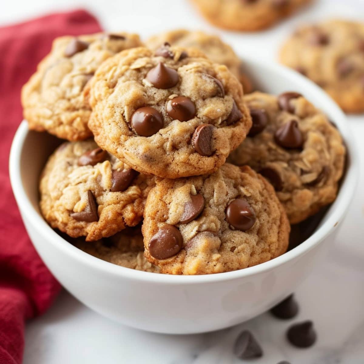 A delectable assortment of chocolate chip cookies arranged in a bowl, tempting with their golden-brown texture and mouthwatering aroma