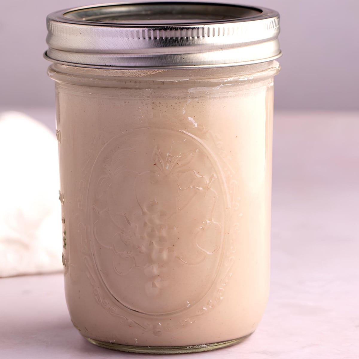Homemade coconut coffee creamer in a mason jar. 