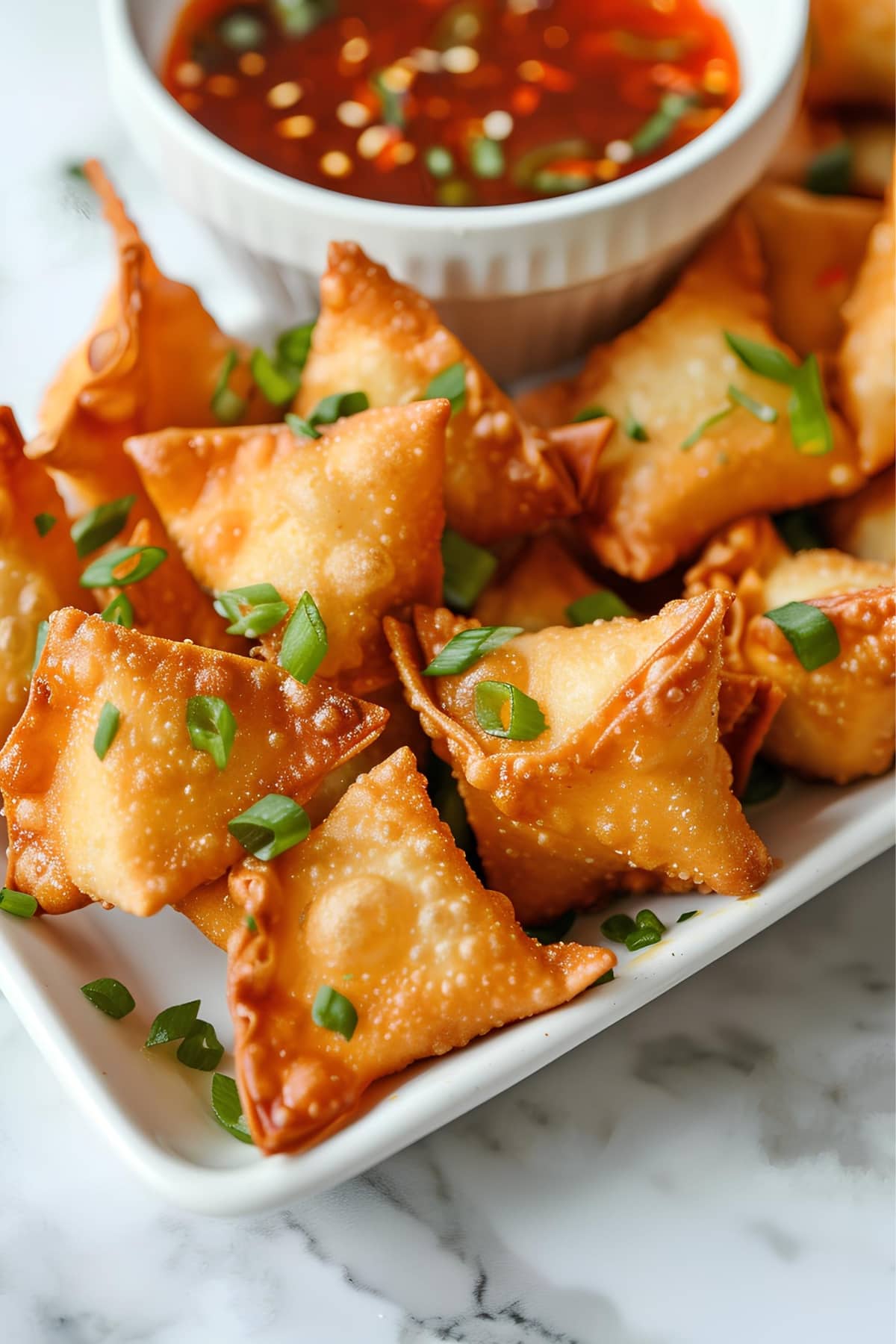 Fried crab rangoon served with sweet chili sauce