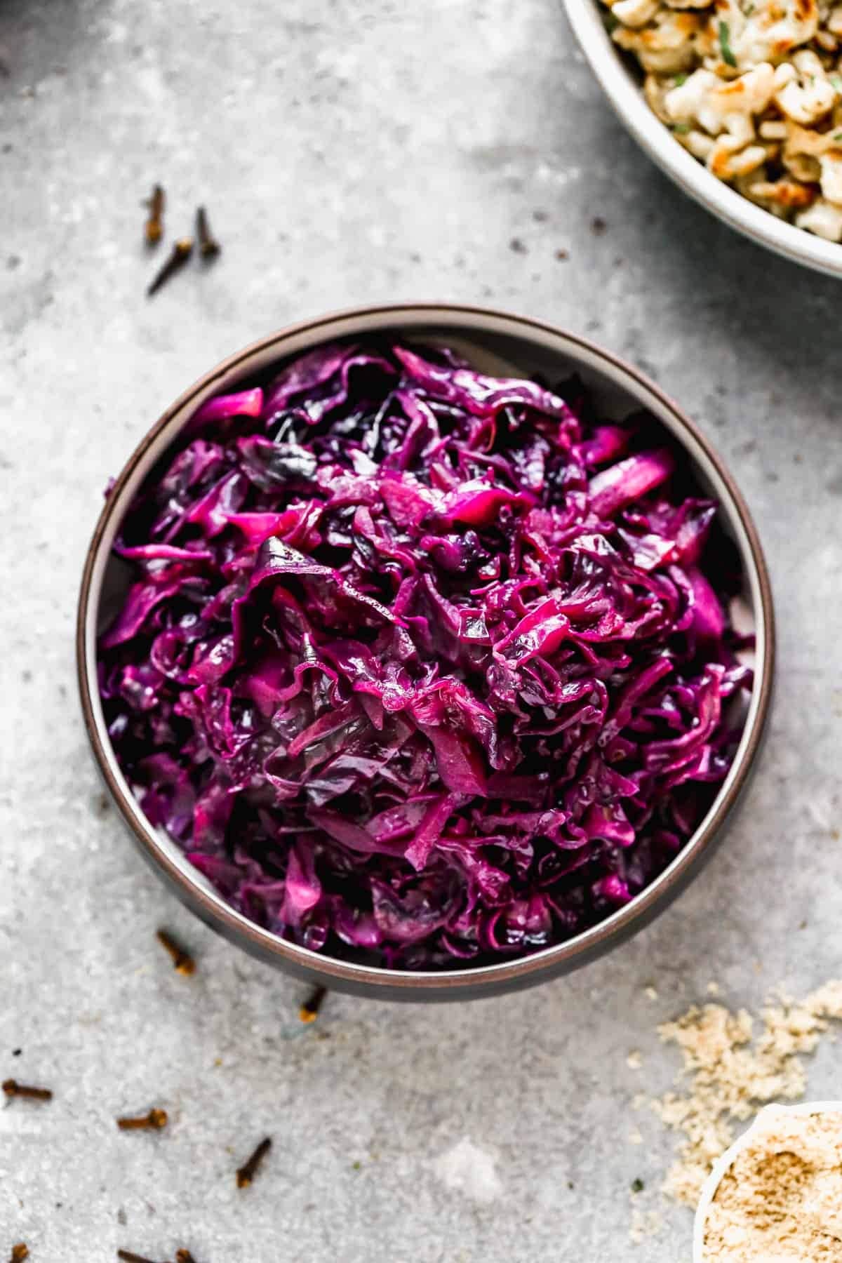 Thinly sliced red cabbage on a wooden bowl. 