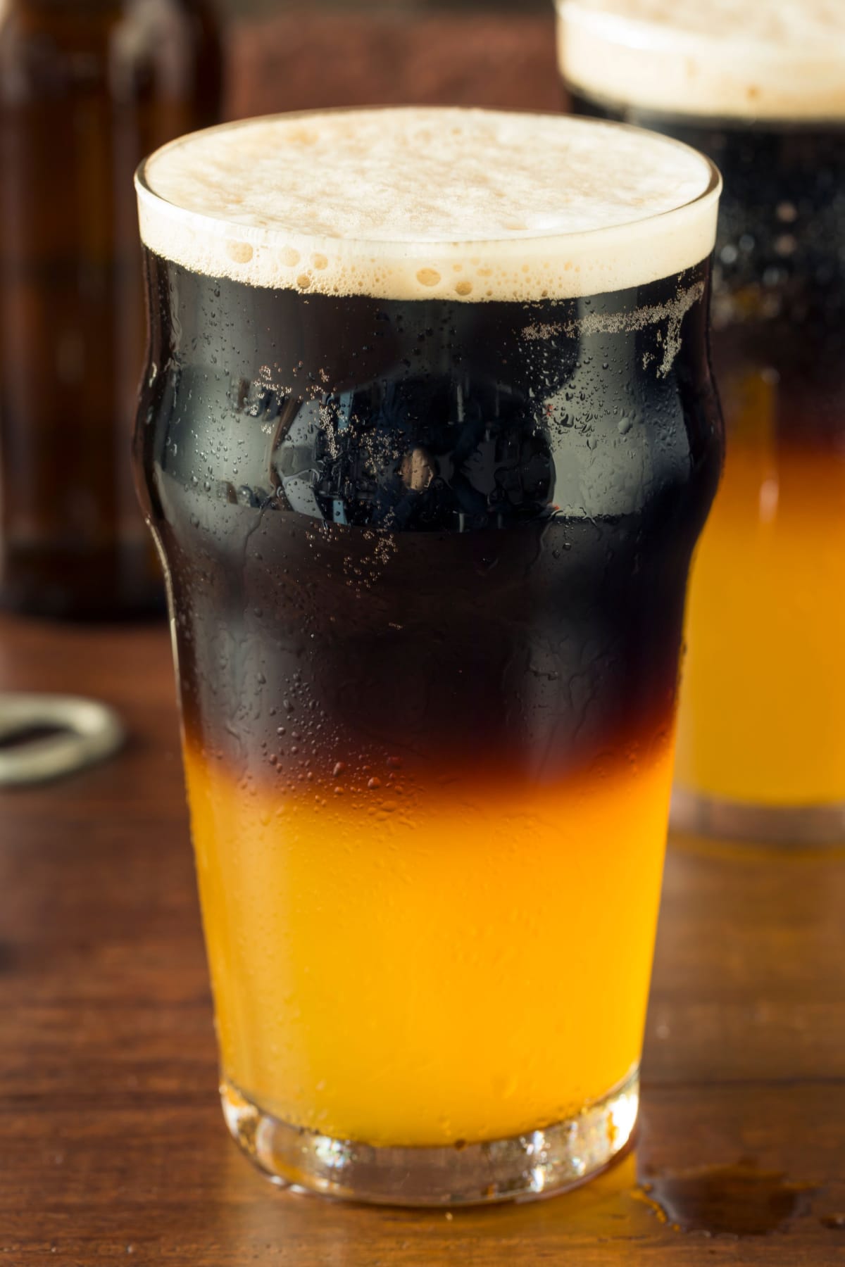 Irish half and half cocktail with pale colored ale on bottom and black beer on top.