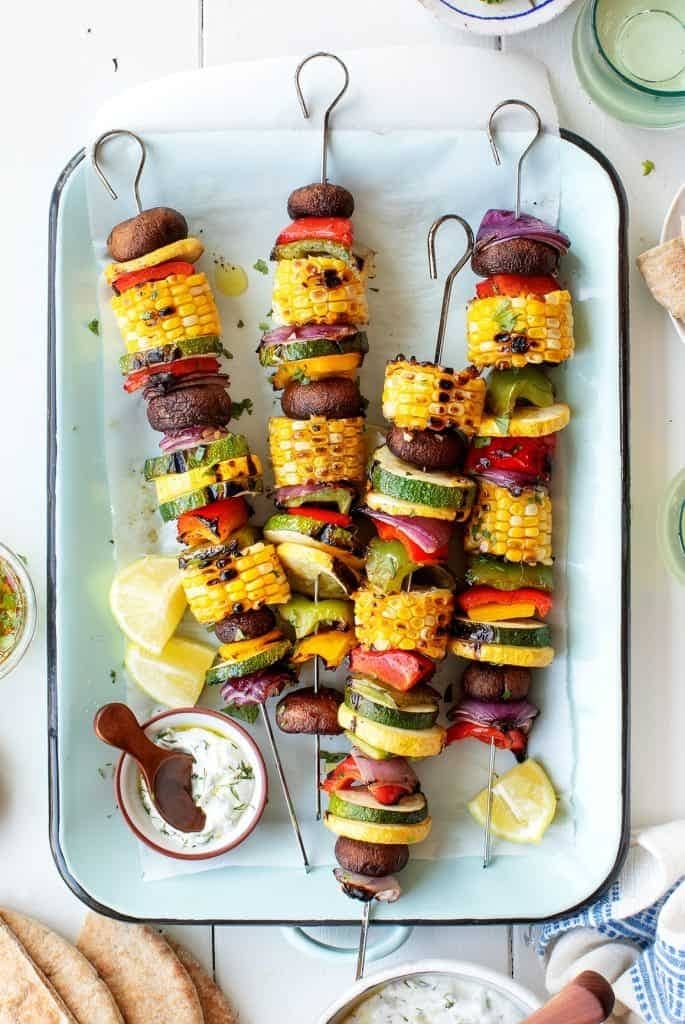Grilled peppers, summer squash, onions, mushrooms, and corn on skewers.