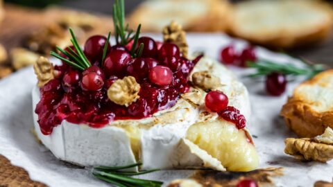 Baked Brie: A delectable dish featuring melted cheese topped with cranberries and walnuts