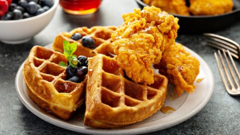 Homemade Chicken and Waffles with Blueberries in a White Plate