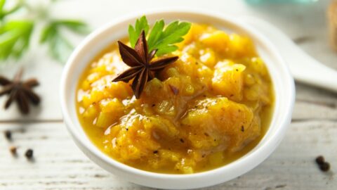 Traditional homemade mango chutney in a small container