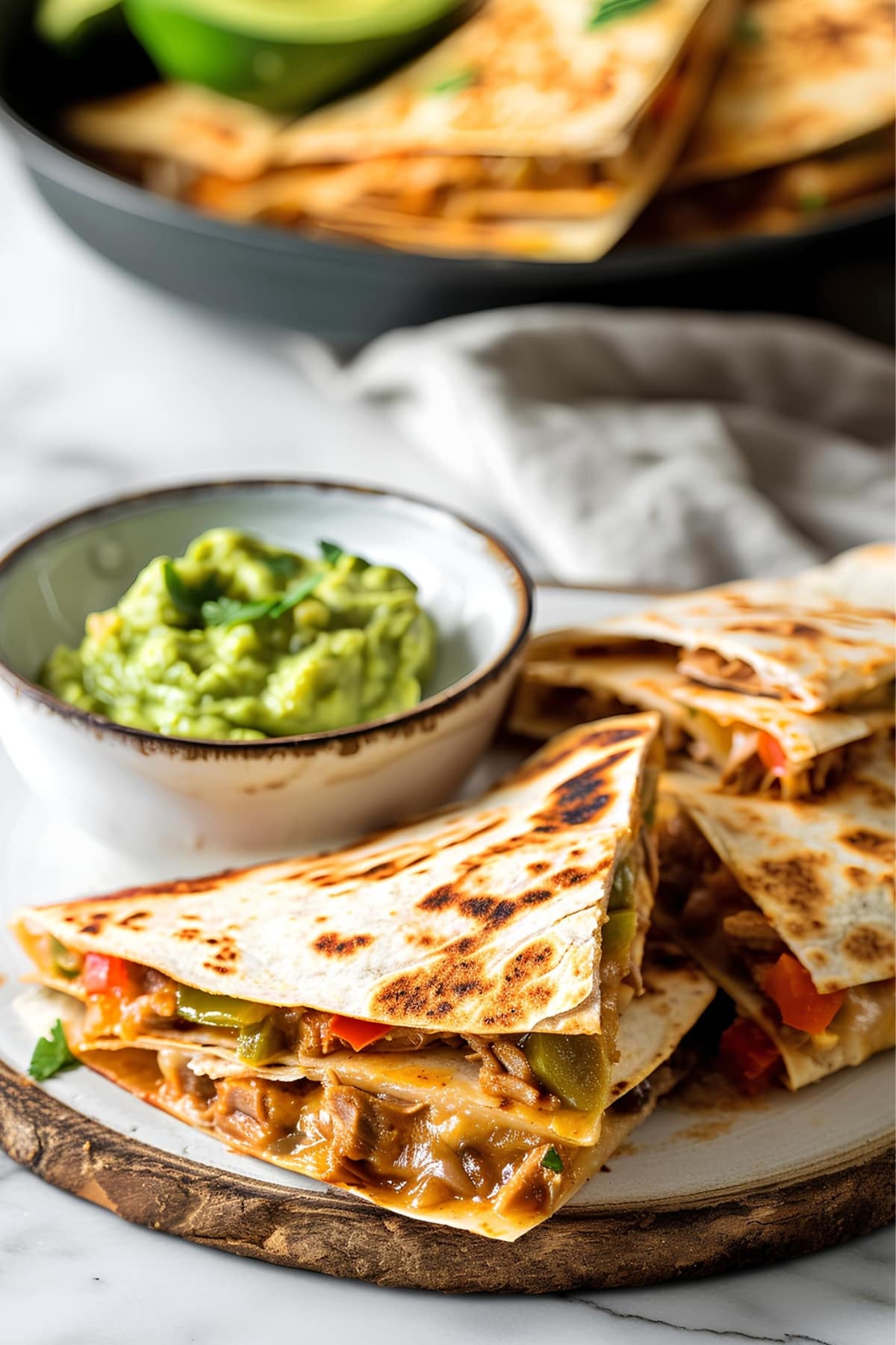 Homemade quesadillas filled with meat and vegetables served with guacamole