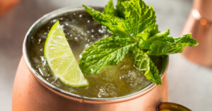 Ice cold Kentucky mule with mint sprig and lime wedge garnish.