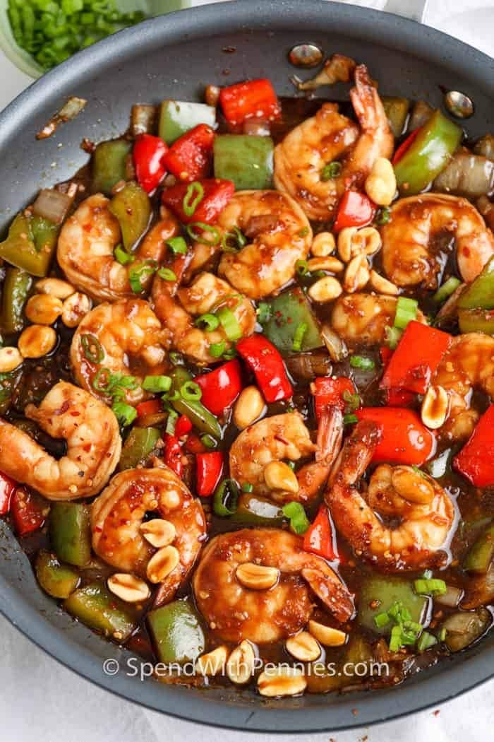 Kung pao shrimp with sauce cooked on pan.