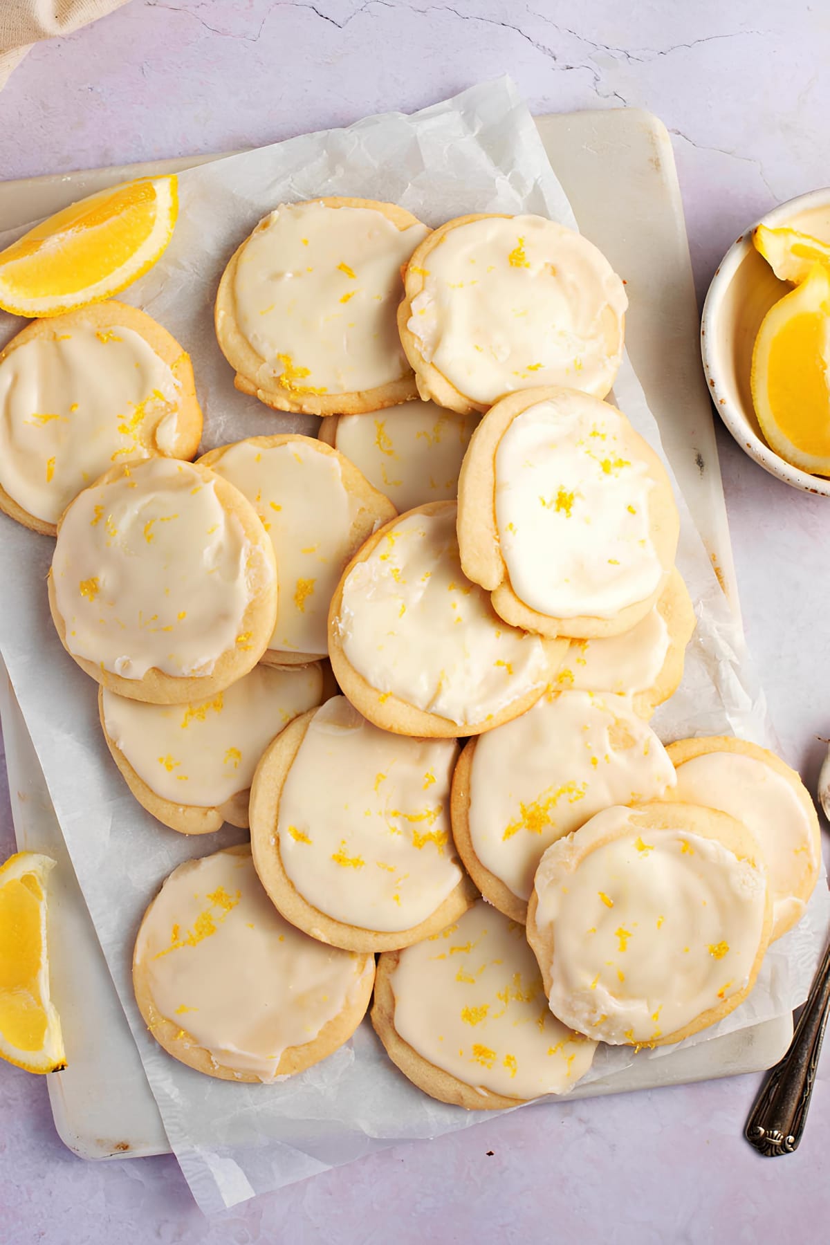 Bunch of lemon shortbread cookies with lemon glaze on top. 