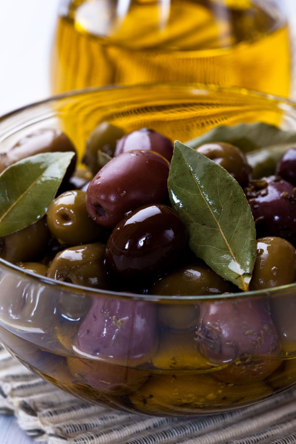 Glass bowl with olives soaked in oil. 