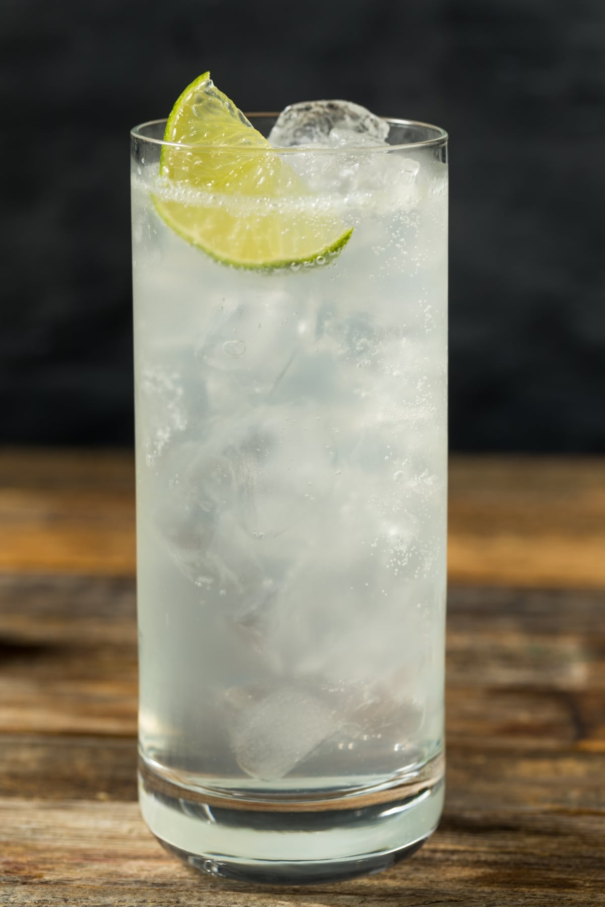 Ranch water cocktail served on a highball glasses filled with ice garnished with a slice of lime.