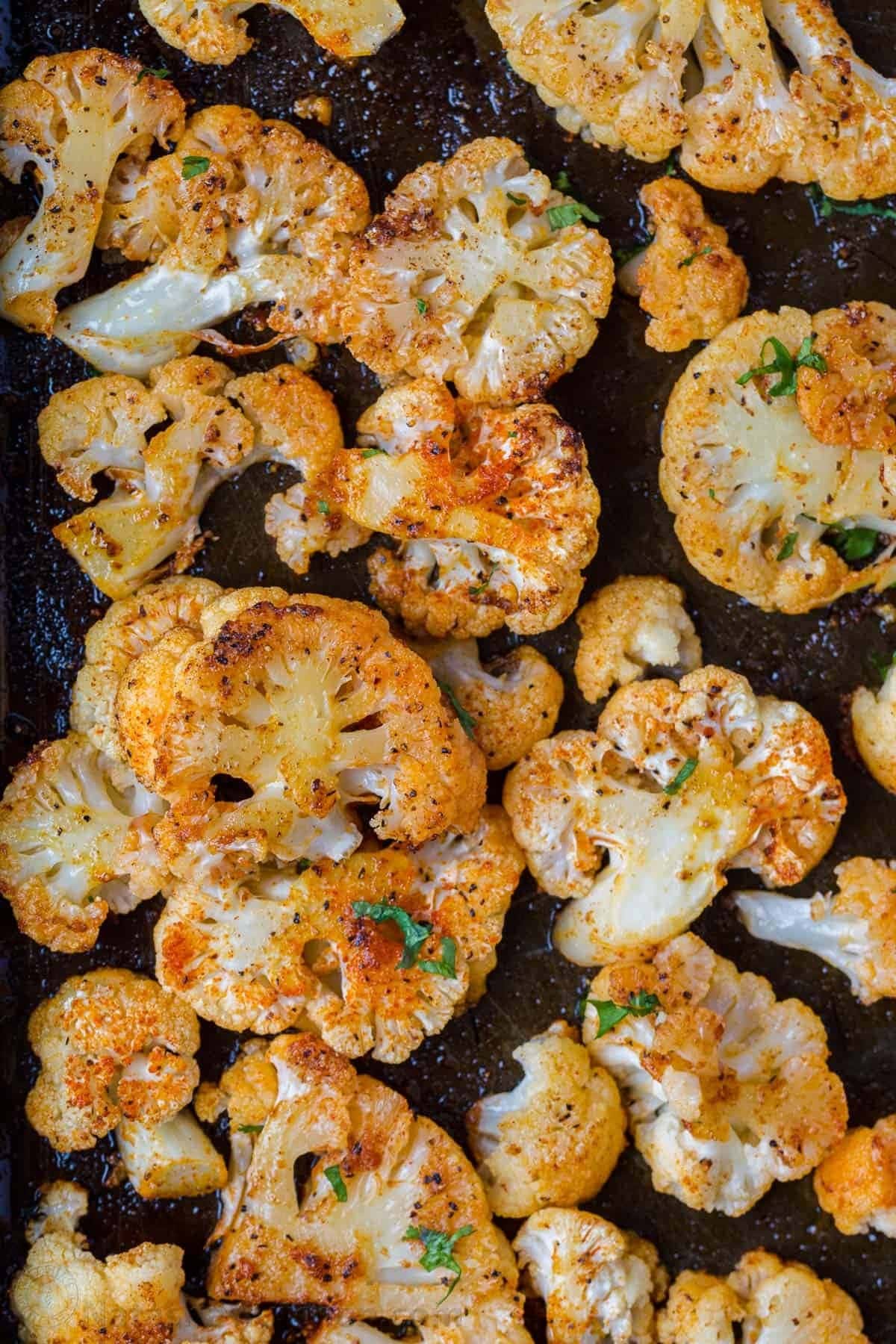 Roasted cauliflower tossed in a cast iron pan.