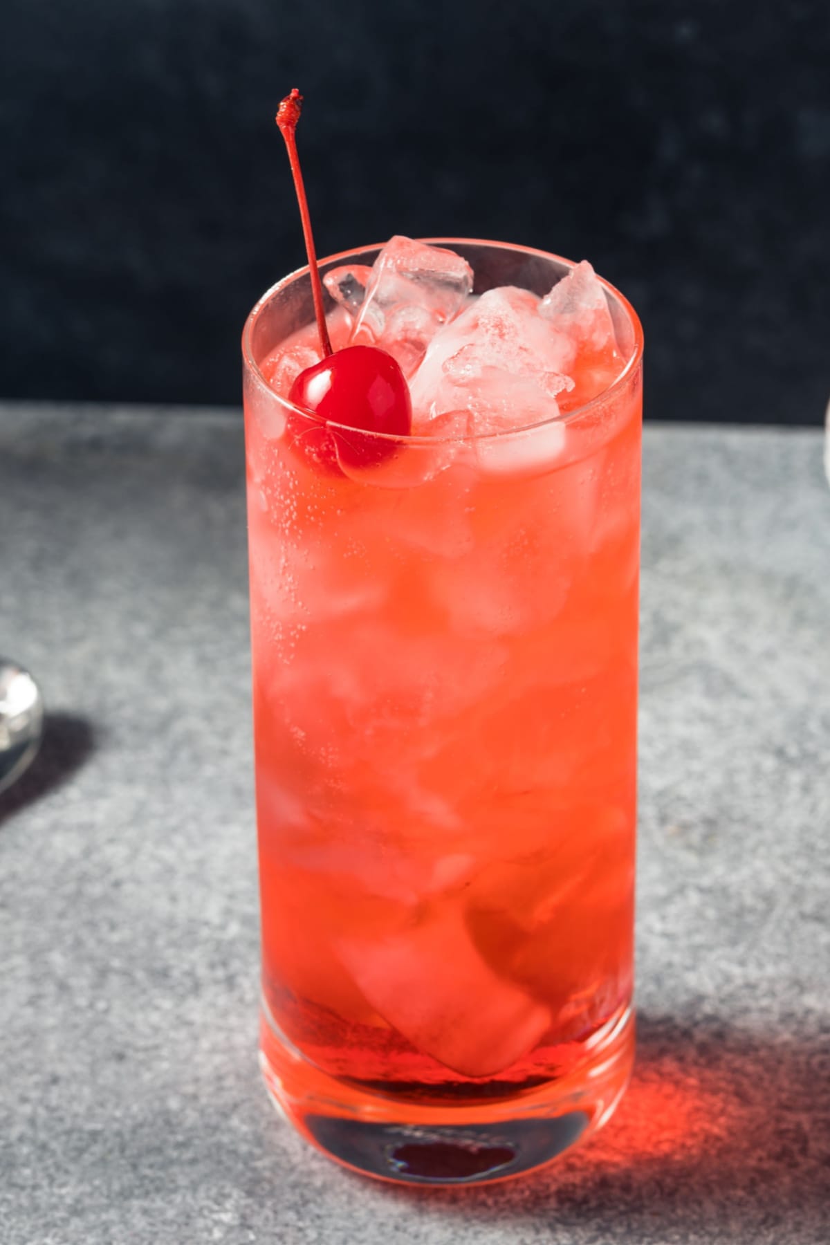 Ice cold Shirley Temple cocktail garnished with fresh cherry.