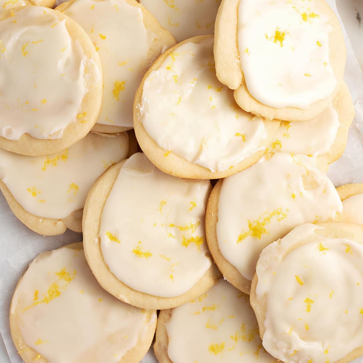 Closeup of lemon shortbread cookies with lemon glaze on top.
