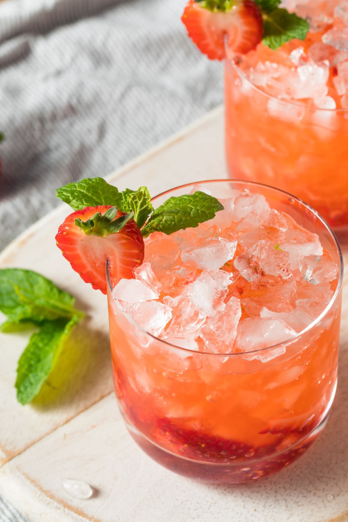 Iced Strawberry gin cocktail in high ball glass. 