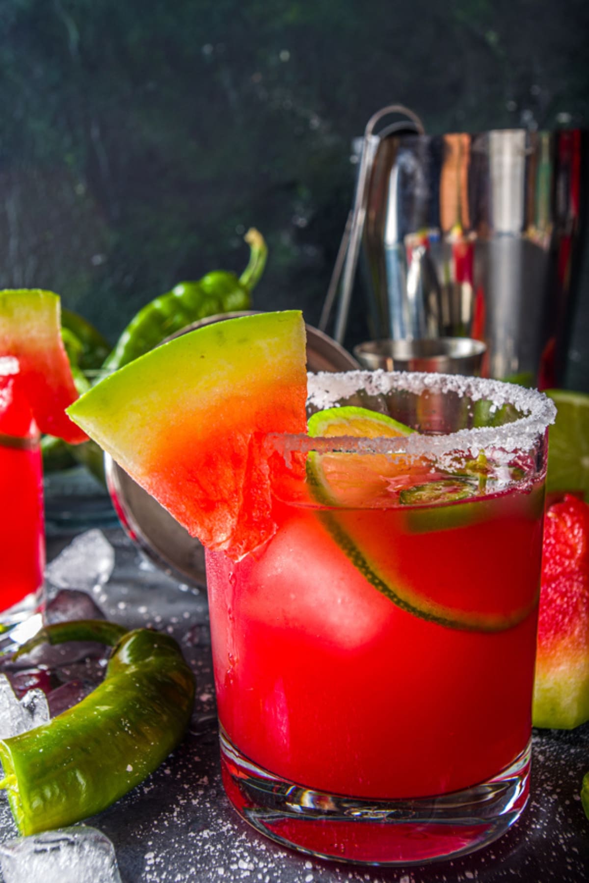 A serving of Tequila Mockingbird cocktail garnished with watermelon and lime slice. 