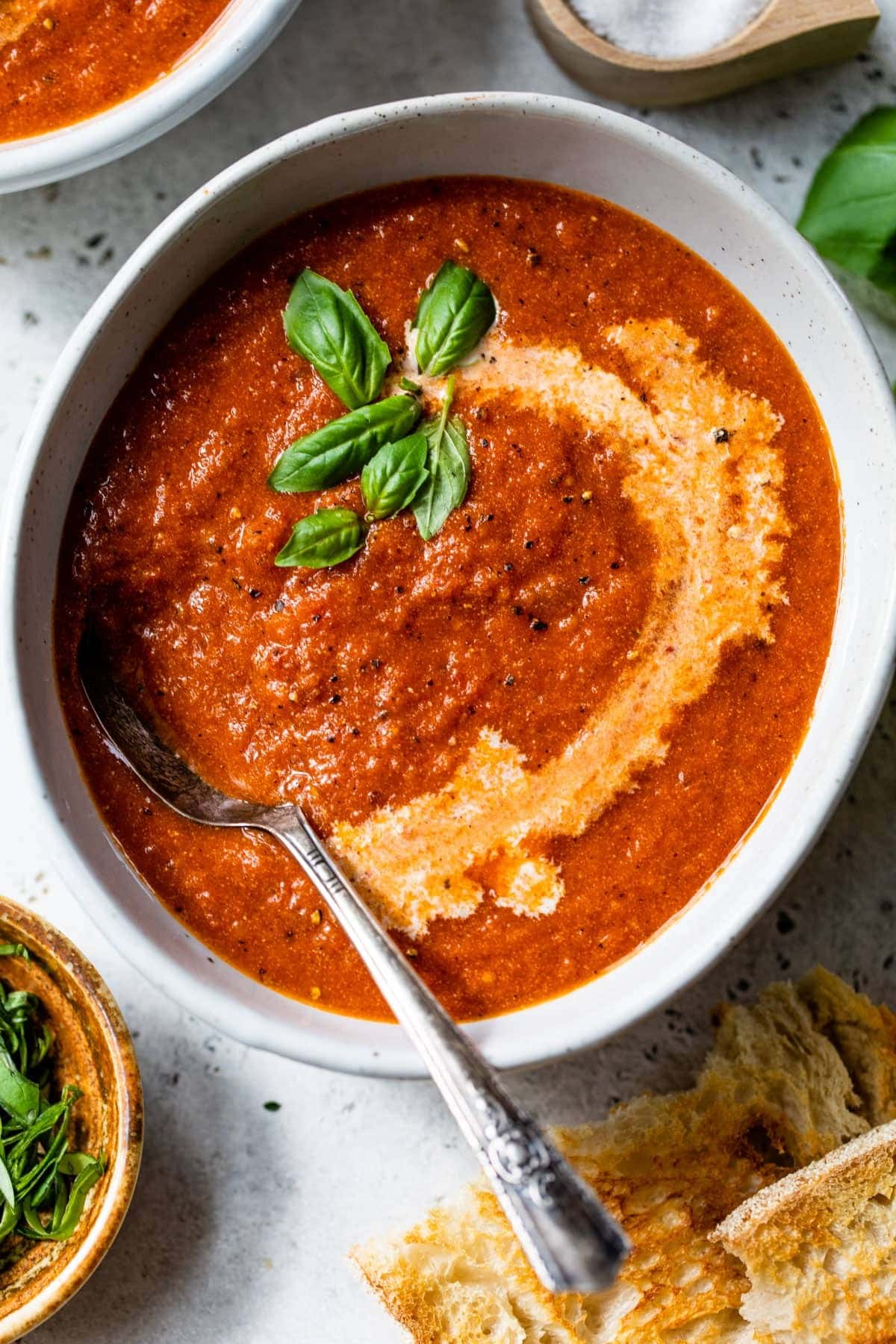 A bowl of tomato bisque with spoon. 