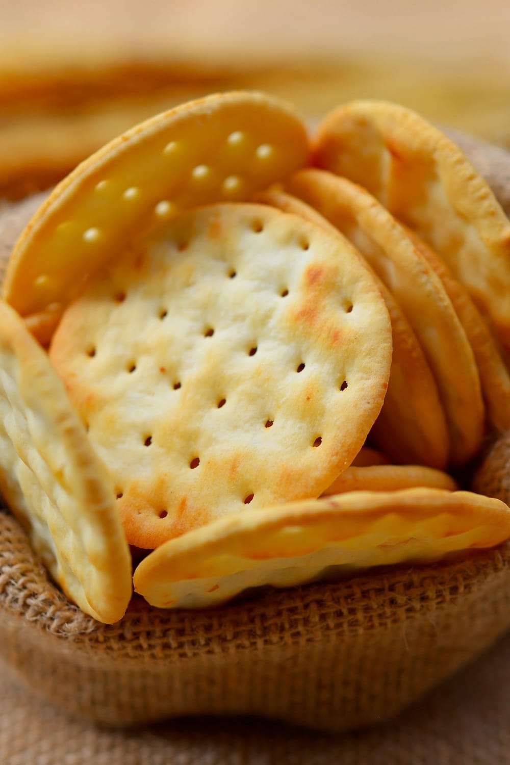 Bunch of water crackers on a wooden bowl.