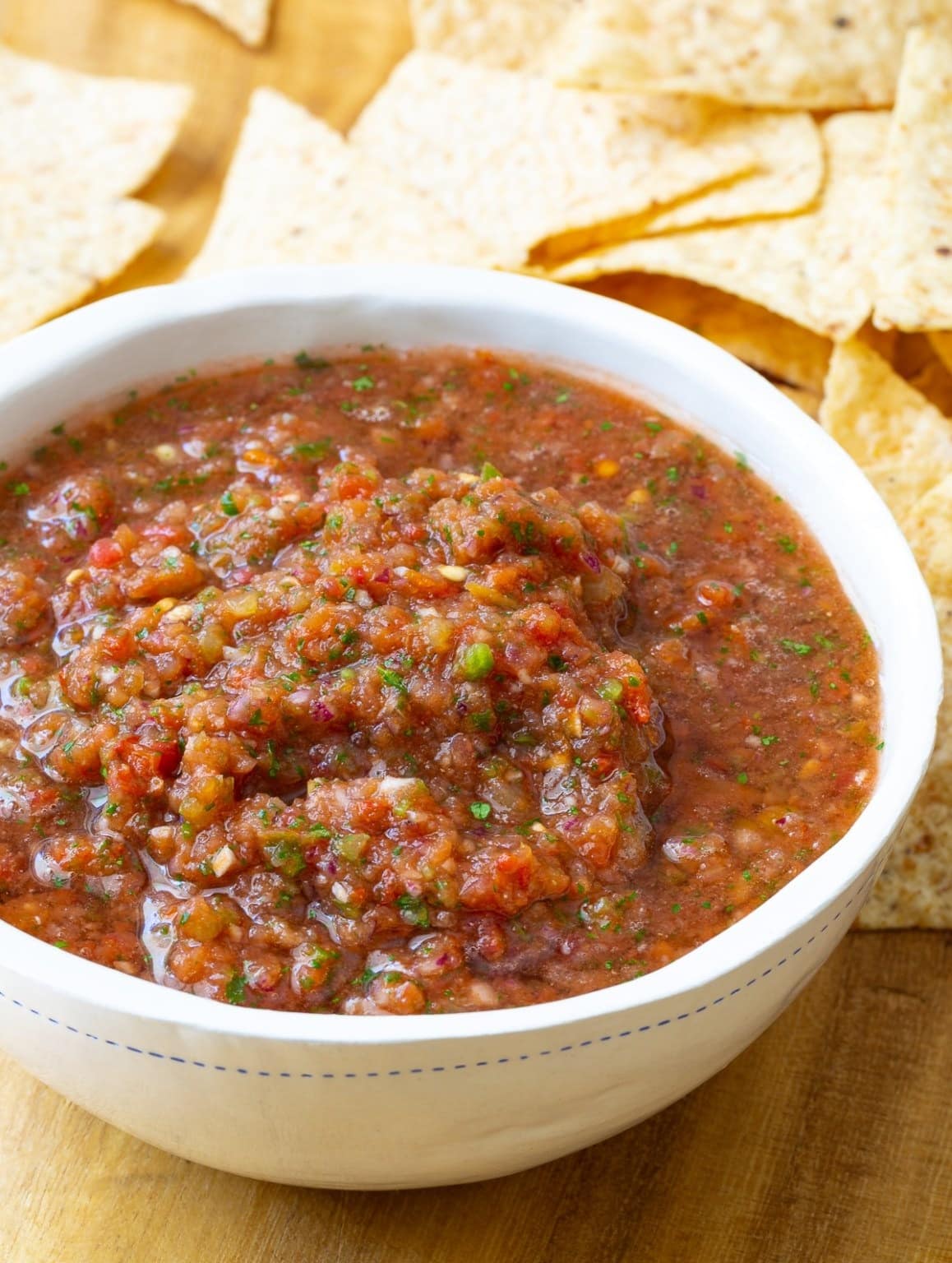 Bowl of homemade salsa with tomatoes, onions, peppers and spices