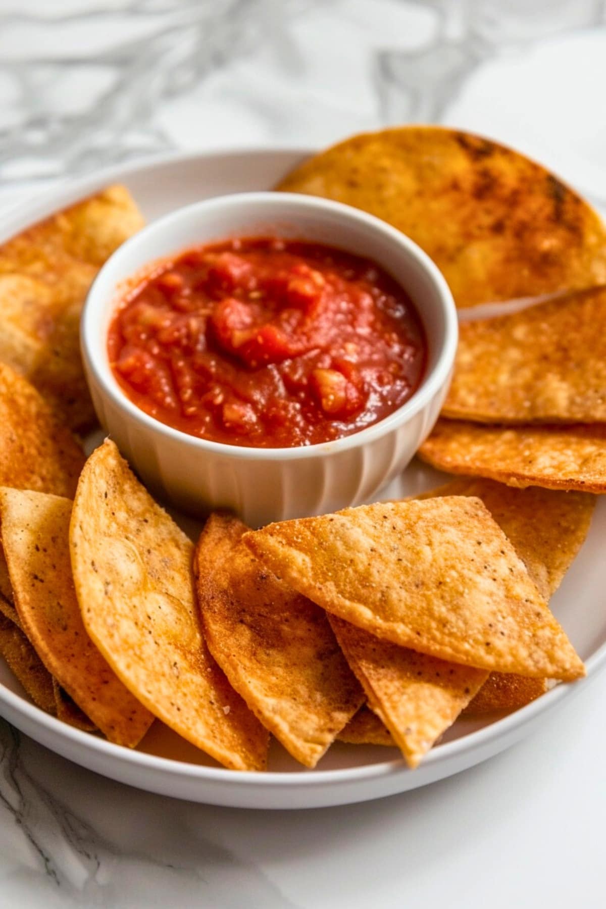 Air fried tortilla chips with a bowl of dipping sauce