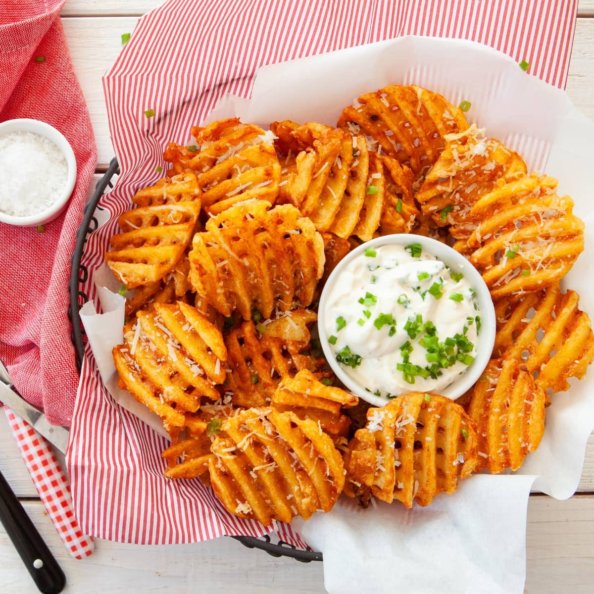 Bunch of waffle fries served with mayo dip.