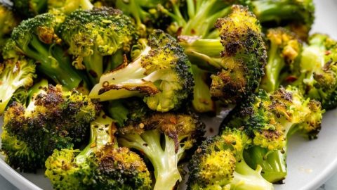 Air fried broccoli in a white plate.